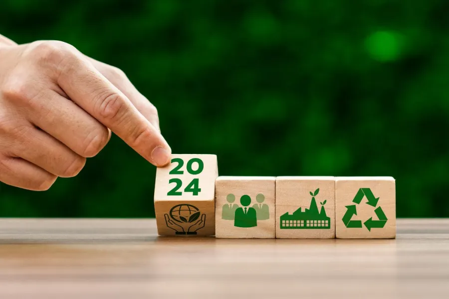 A hand laying wooden tiles with sustainability simbols.